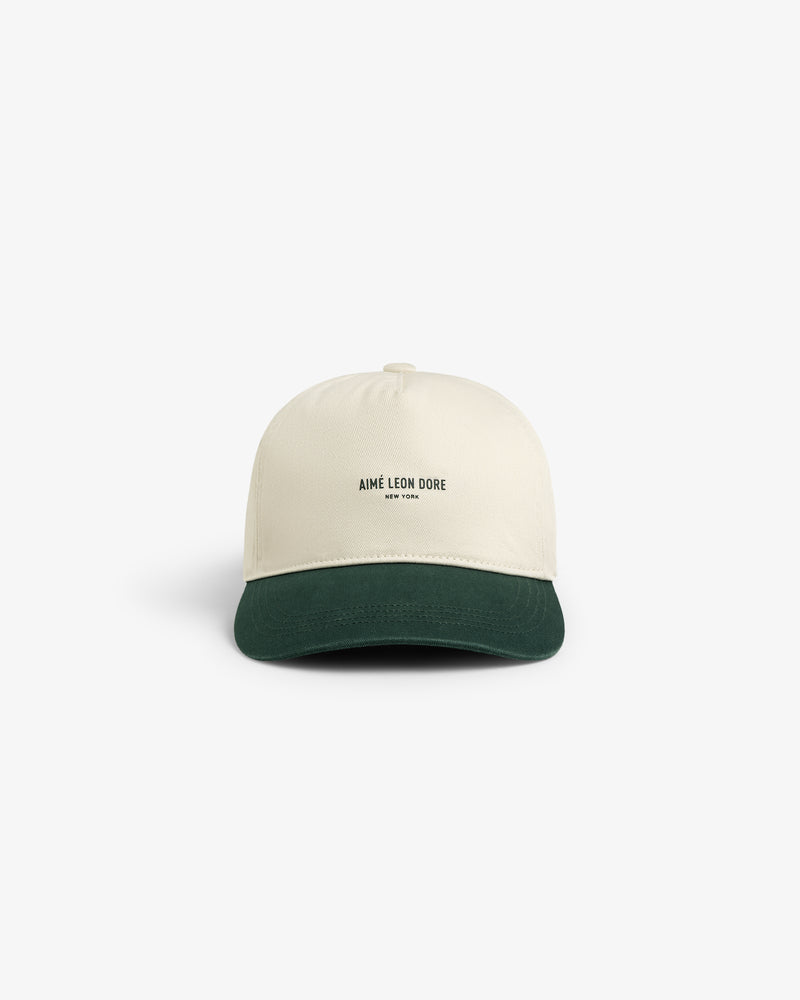 Micro Logo Hat in cream with a dark green brim and Aimé Leon Dore New York text, shown on a white background.