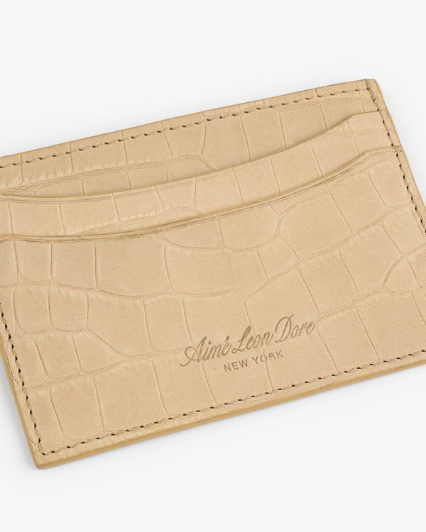 Beige Croc-Embossed Nubuck Cardholder with “Aimé Leon Dore New York” embossed on the front.