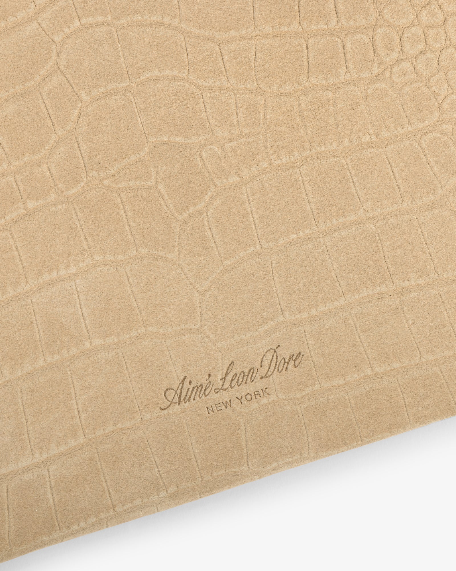 Small Croc-Embossed Nubuck Pouch in beige with Aimé Leon Dore New York embossed in cursive at the bottom center.