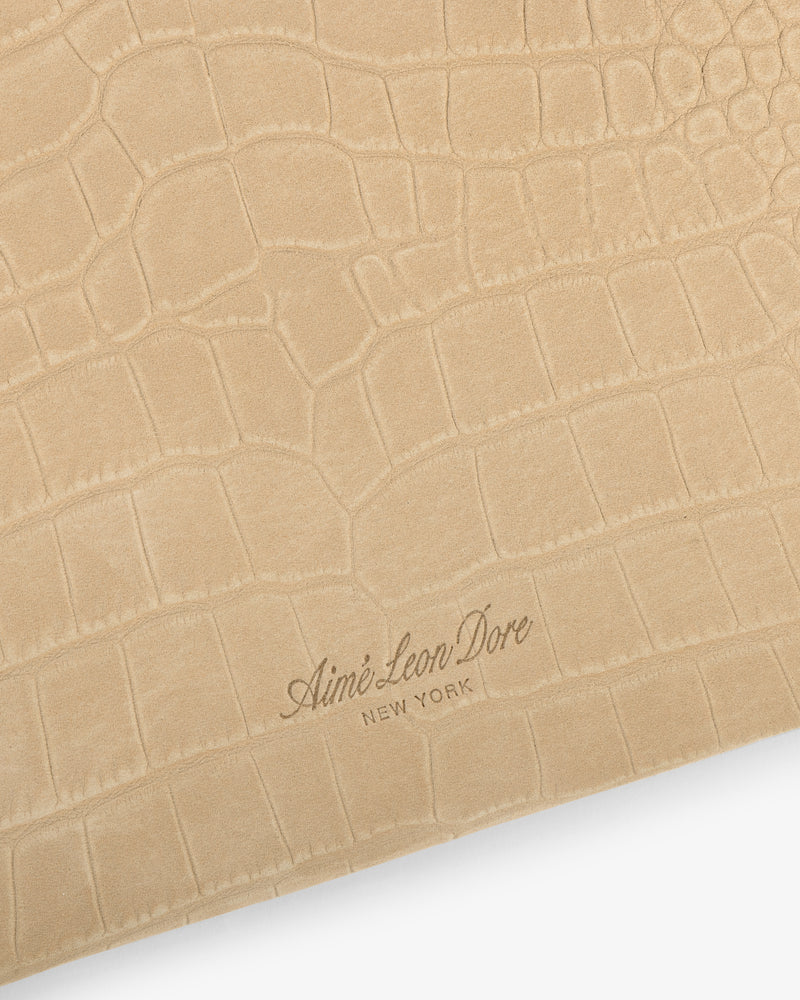 Small Croc-Embossed Nubuck Pouch in beige with Aimé Leon Dore New York embossed in cursive at the bottom center.