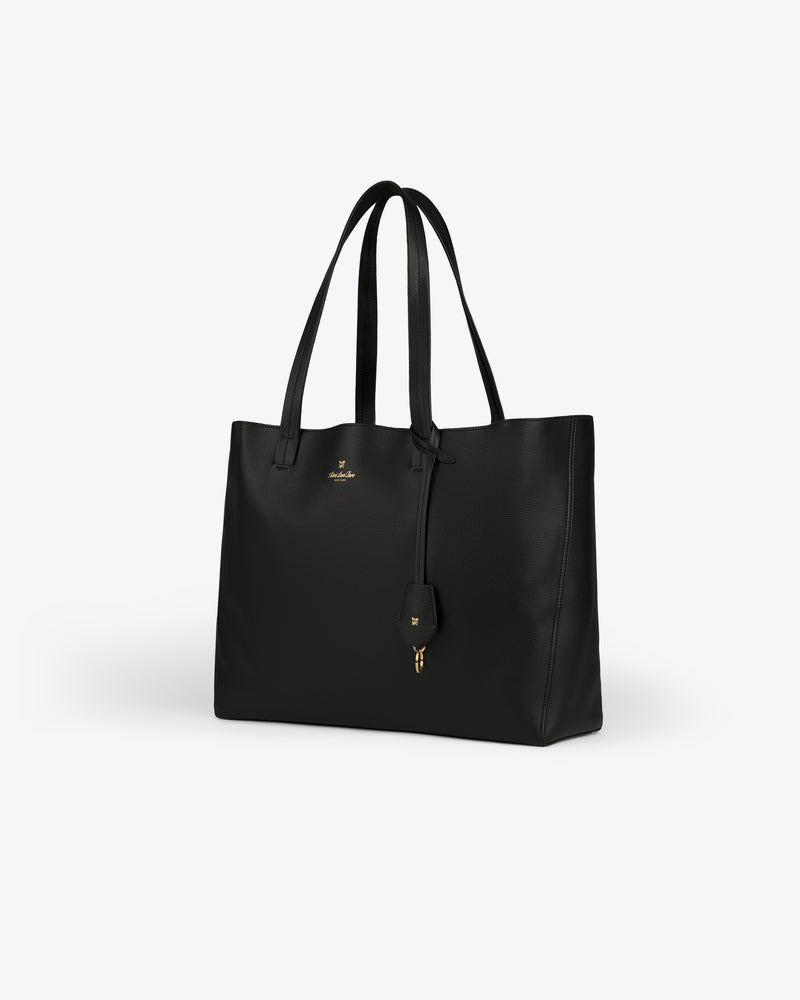 Full Grain Leather Tote Bag with double handles, gold logo, and a small hanging keychain accessory.