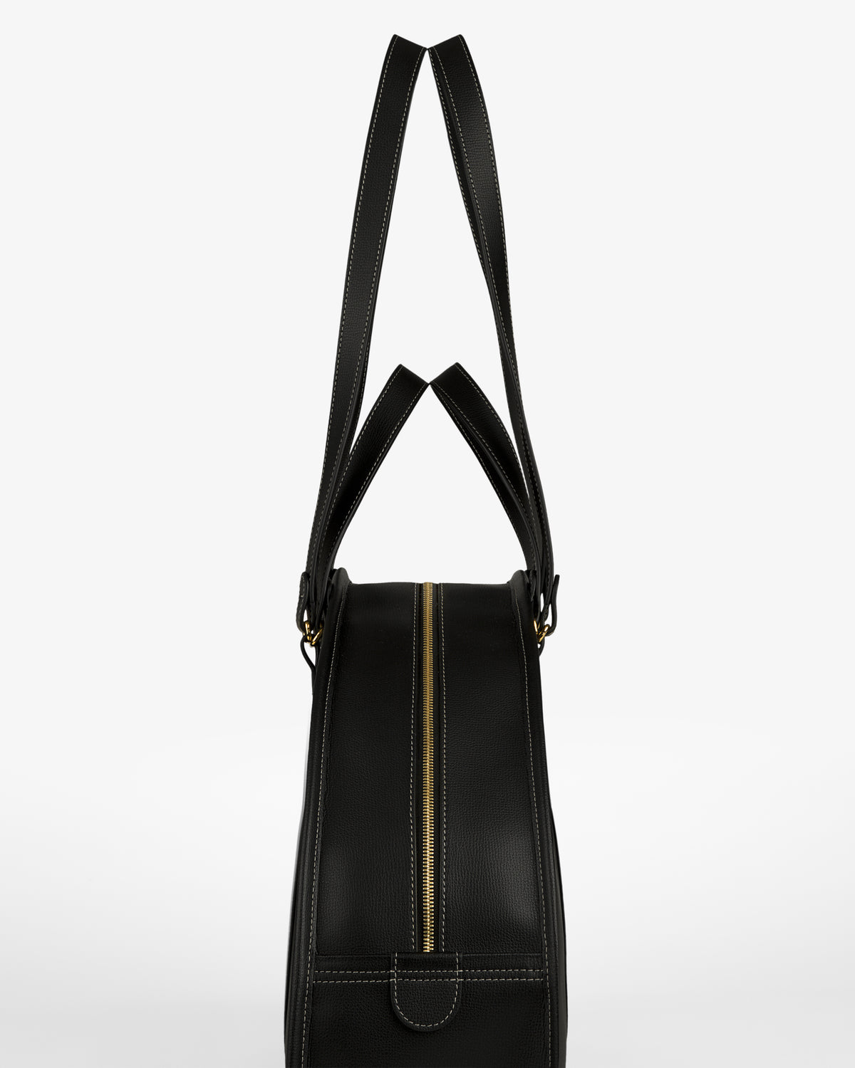 Full Grain Leather Weekender Bag in black with gold zipper, side view, two handles upright on white background.