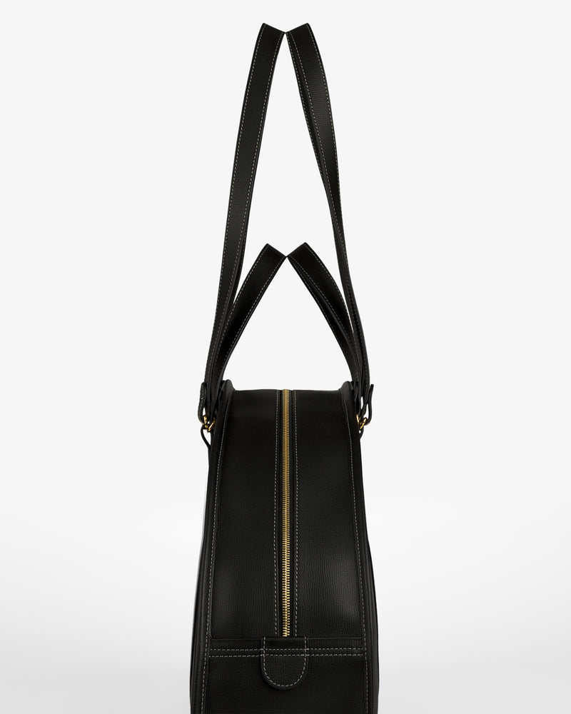 Full Grain Leather Weekender Bag in black with gold zipper, side view, two handles upright on white background.