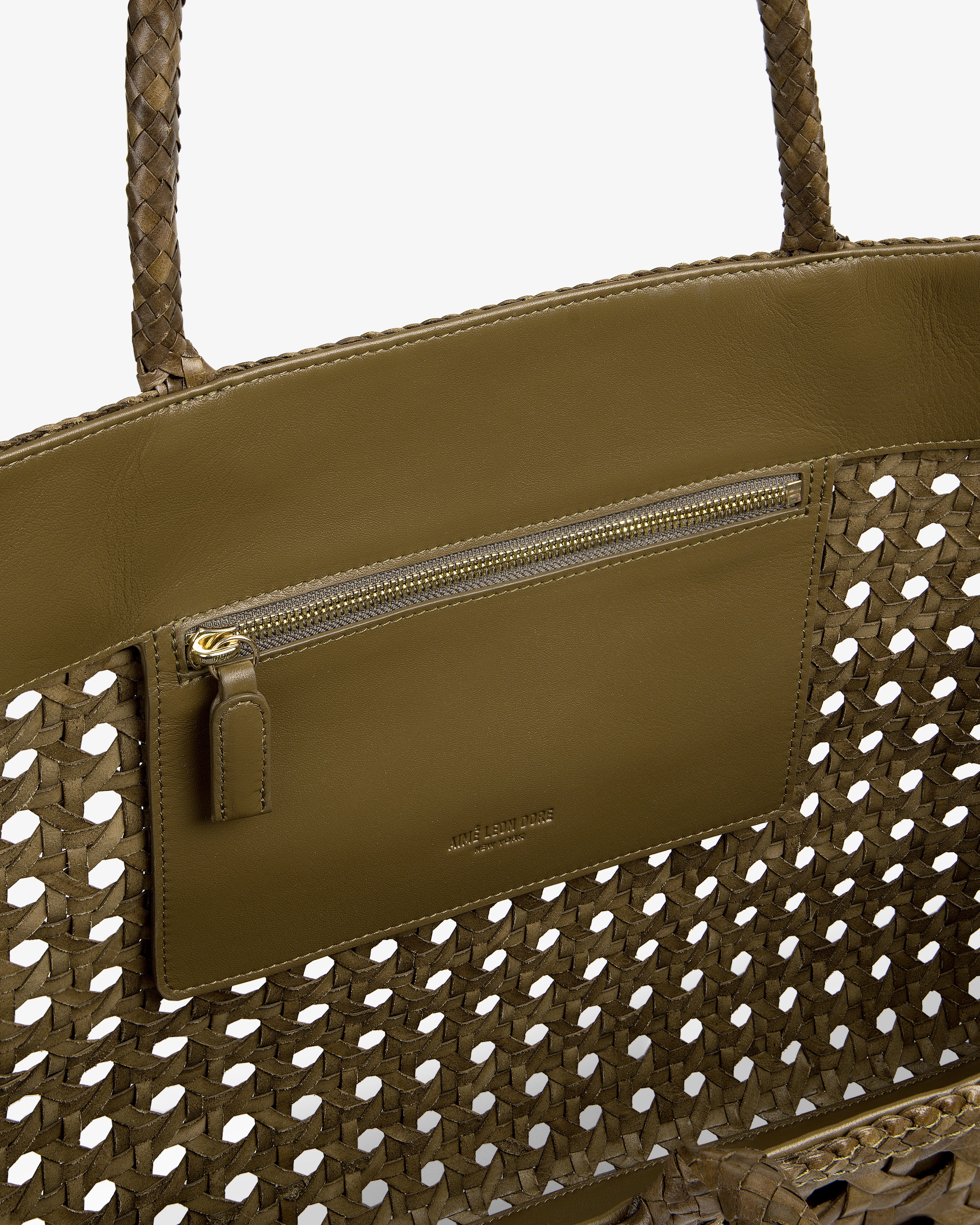 Interior view of the Woven Leather Tote Bag in olive green, featuring a zip pocket and leather trim.