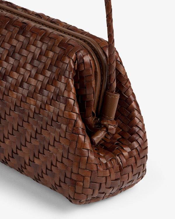 Close-up of the Woven Leather Shoulder Bag, featuring brown leather, a zipper, and a braided strap on white background.