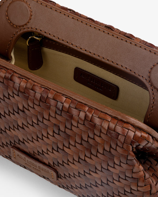 Close-up of the Woven Leather Shoulder Bag in brown with a tan interior and a visible zippered pocket.