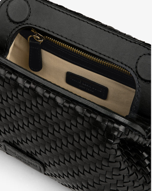 Close-up of the Woven Leather Shoulder Bag, open to reveal a beige interior, zip pocket, and black label.