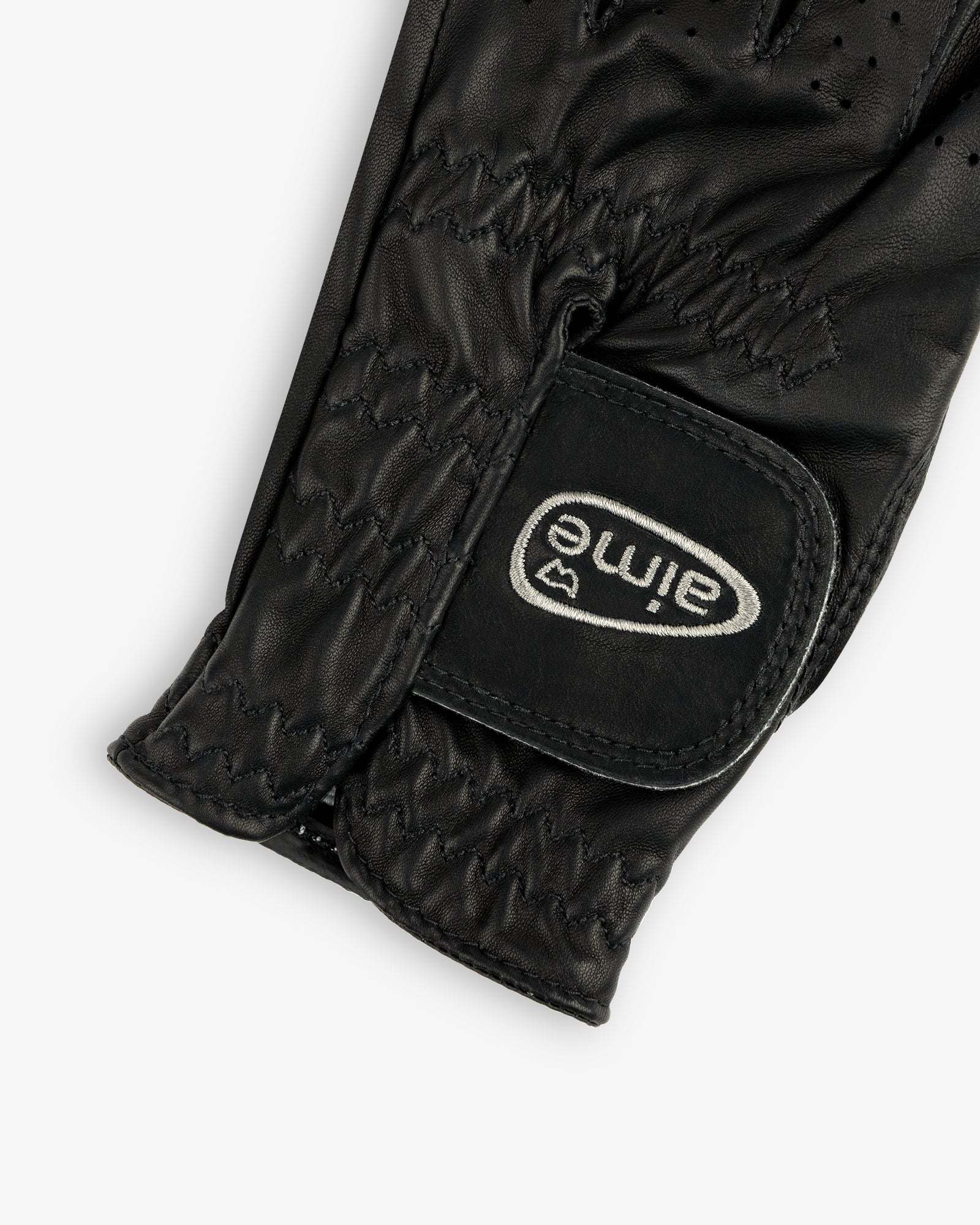Close-up of the ALD / FootJoy StaSof Heritage Glove (Left), black leather with visible stitching and aimé Velcro strap.