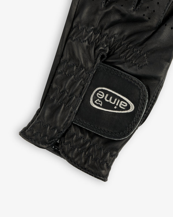 Close-up of the ALD / FootJoy StaSof Heritage Glove (Left), black leather with visible stitching and aimé Velcro strap.