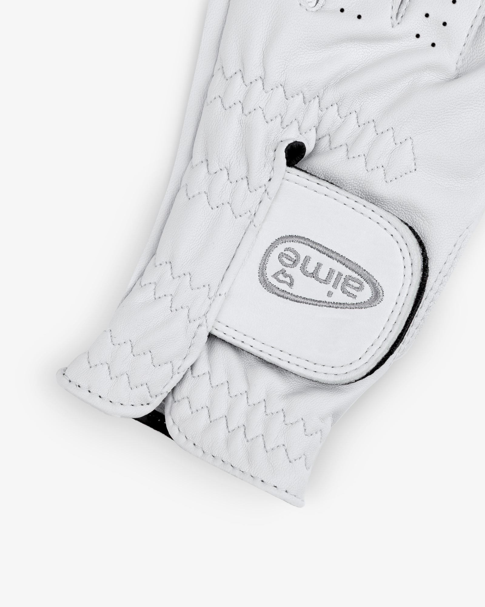 A close-up of the ALD / FootJoy StaSof Heritage Glove (Left) with a Velcro strap labeled "elime" in gray.