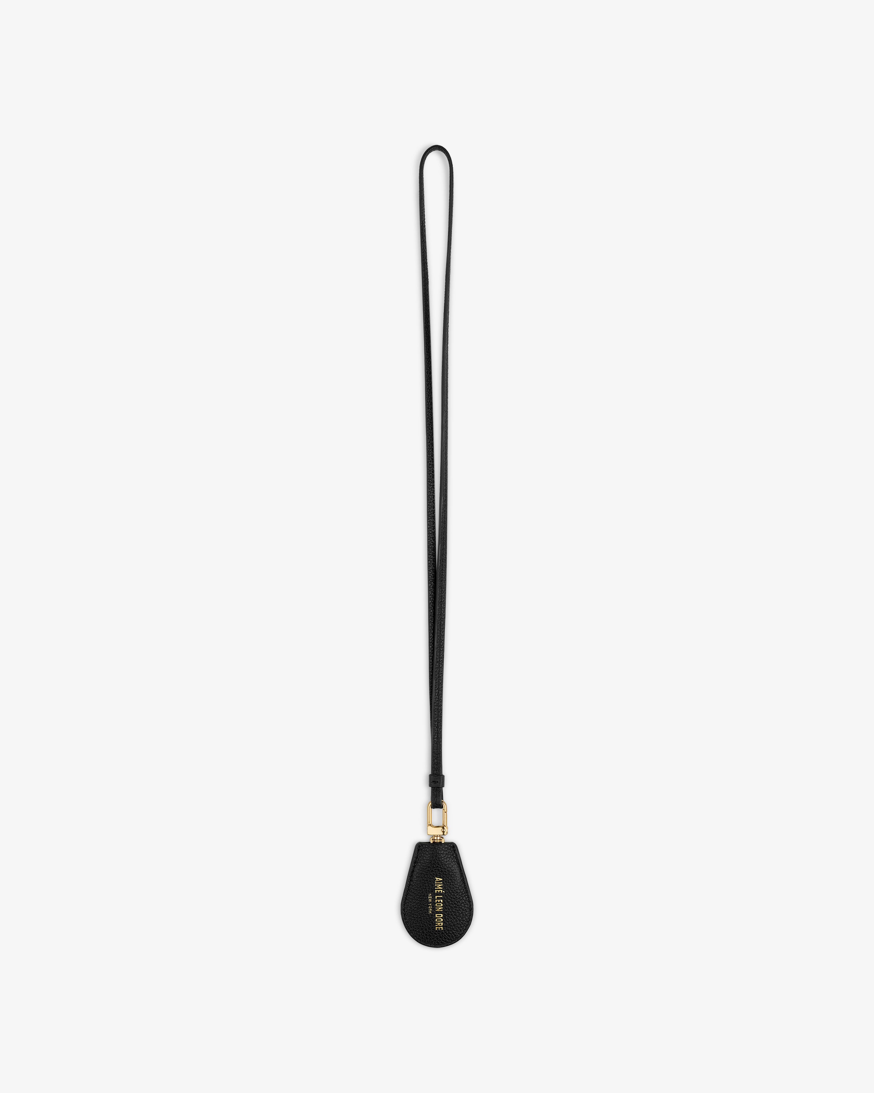 A black Leather Key Cover with gold hardware and text on the teardrop end, shown on a white background.