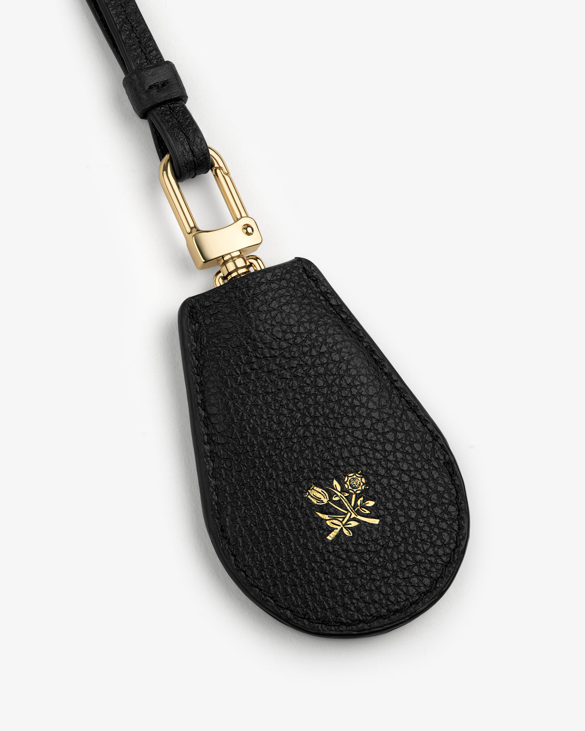 Leather Key Cover in black leather with gold hardware and a small gold floral design on the front.