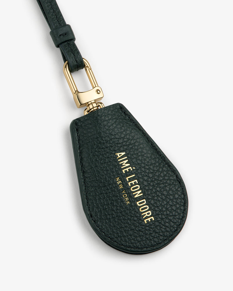 Black Leather Key Cover with gold hardware and AIMÉ LEON DORE NEW YORK embossed in gold lettering.