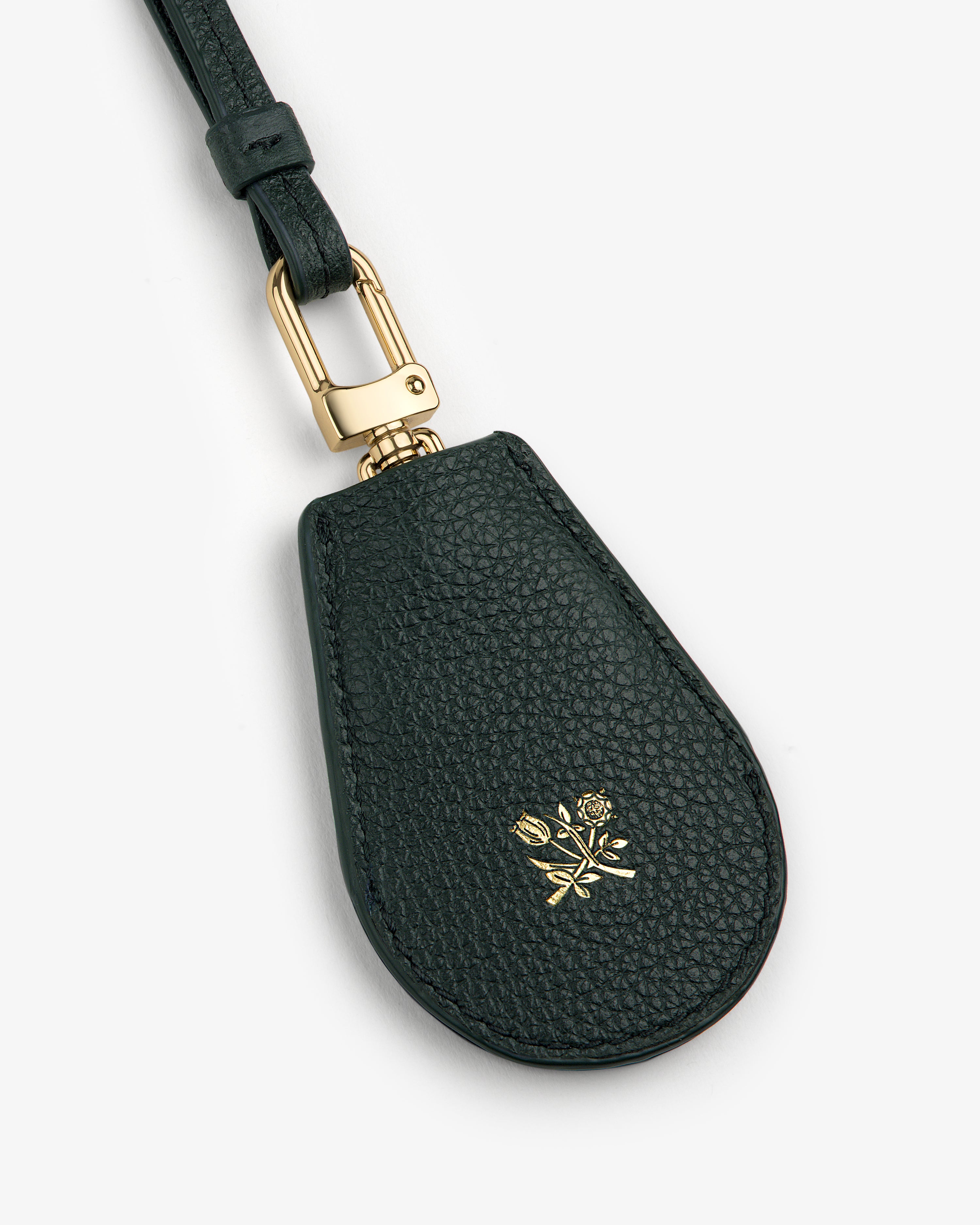 Leather Key Cover in black with gold clasp and a small embossed gold rose emblem on the front.