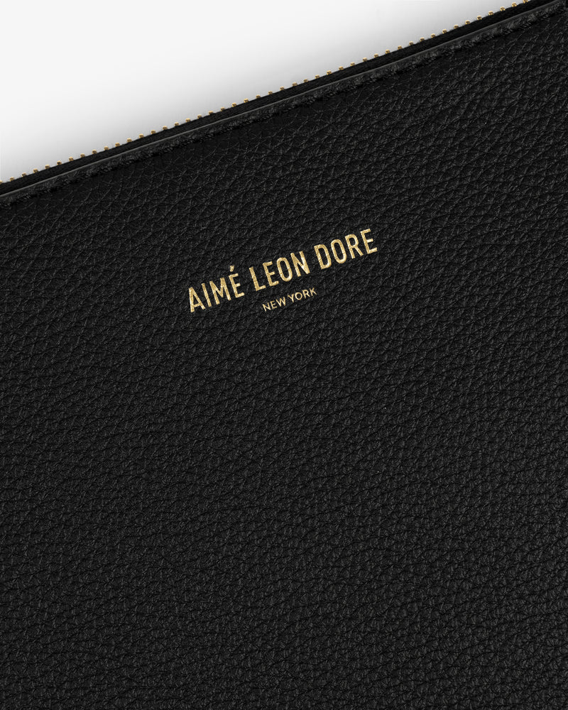Black textured leather Large Leather Pouch with gold AIMÉ LEON DORE NEW YORK text embossed on the surface.