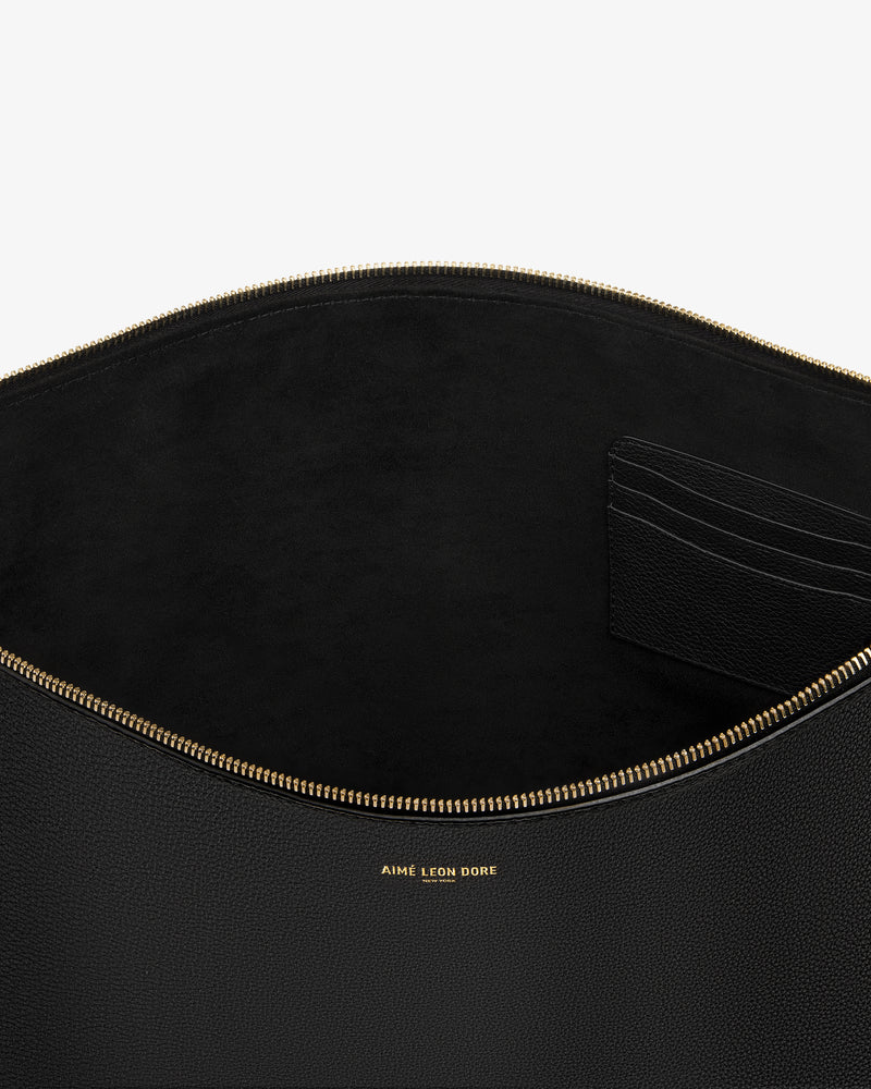 Open Large Leather Pouch in black leather with gold zipper and "Aime Leon Dore" text, revealing card slots inside.