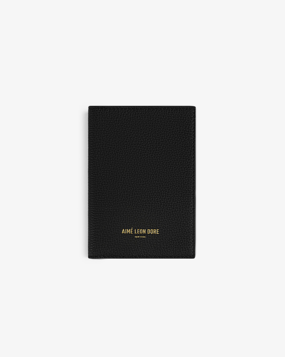 Black textured Leather Passport Holder with AIMÉ LEON DORE gold lettering at the bottom center.