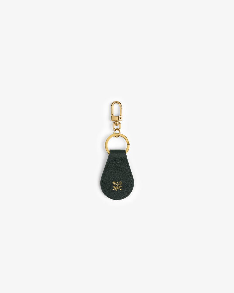 Dark green Leather Key Fob with gold hardware and a small gold emblem, shown on a white background.