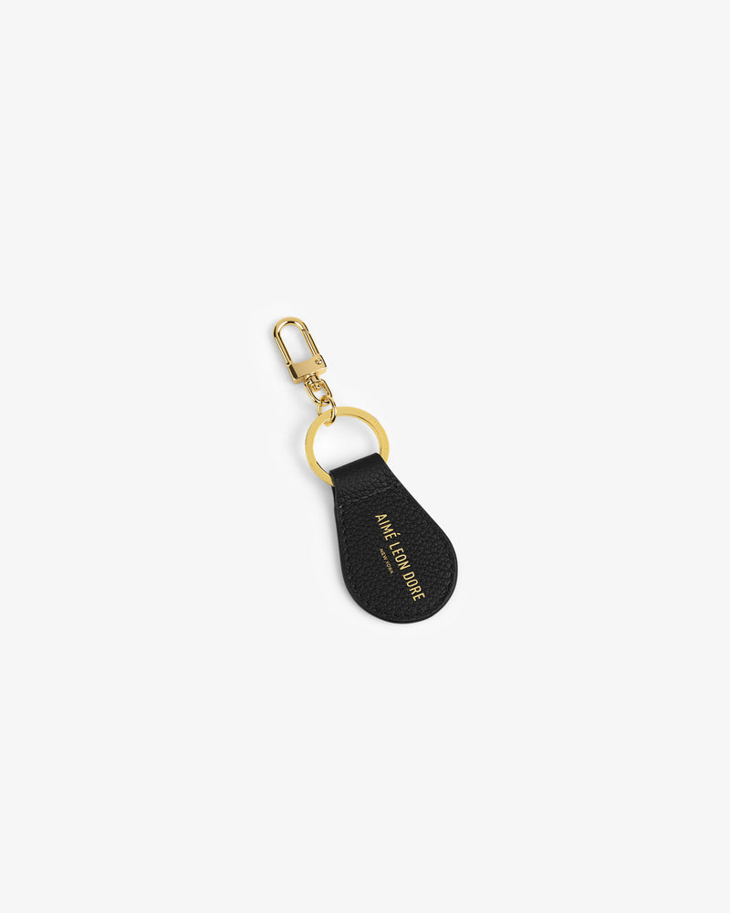 Leather Key Fob in black with gold tone ring, lobster clasp, and JANE CARR LONDON in gold lettering.