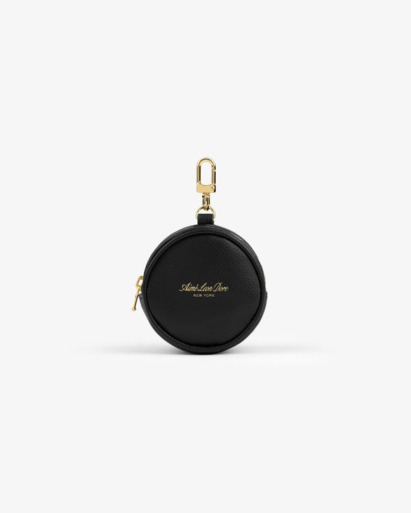 Full Grain Leather Keychain Pouch—small, round, black, with gold zipper, clip, and gold front text on white background.