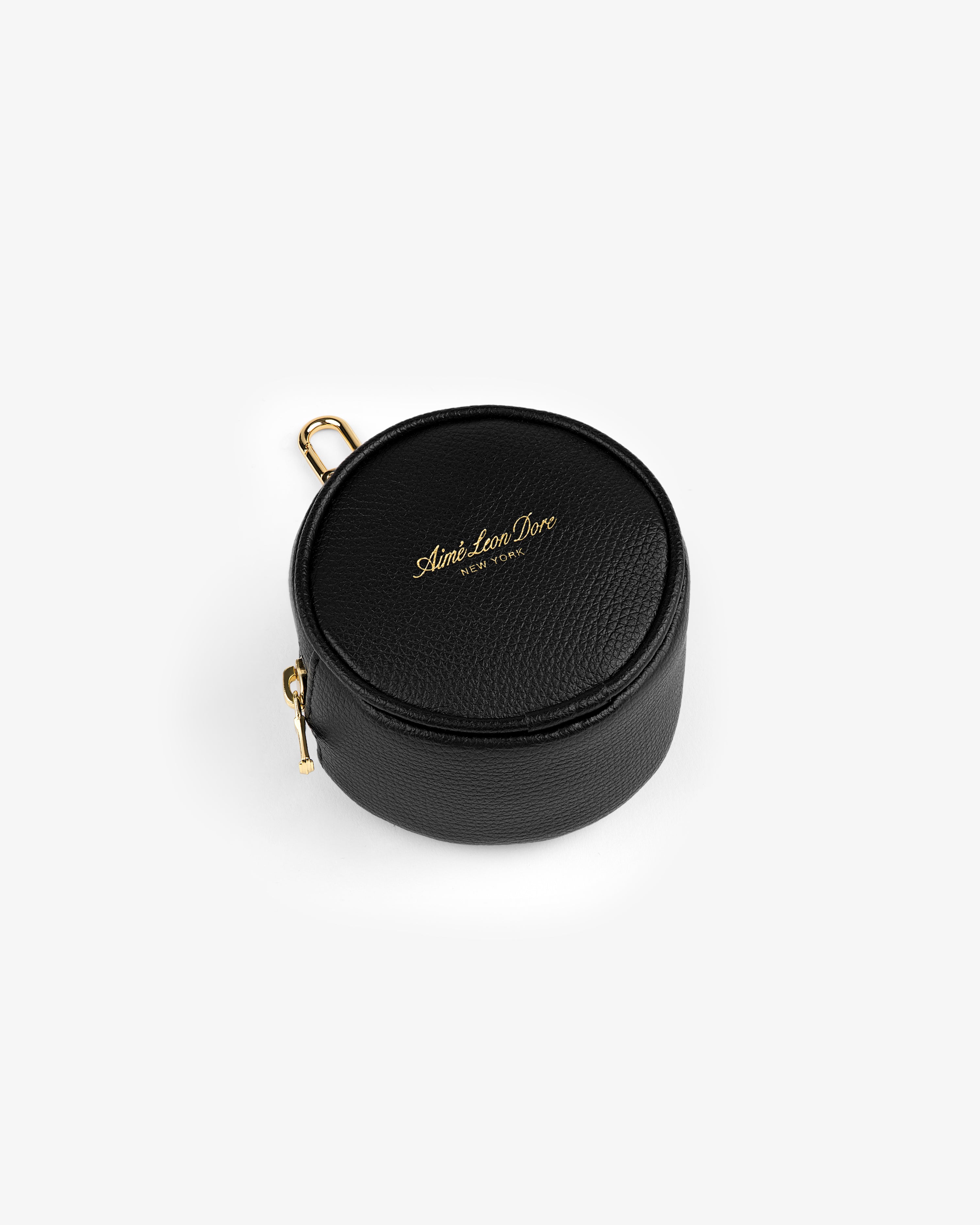 Full Grain Leather Keychain Pouch: round black leather case with gold zipper, clip, and Aimé Leon Dore logo on top.