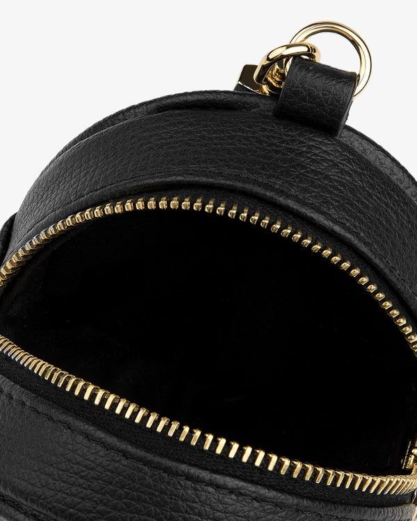 Close-up of a Full Grain Leather Keychain Pouch in black with gold zipper partially open, showing empty interior.