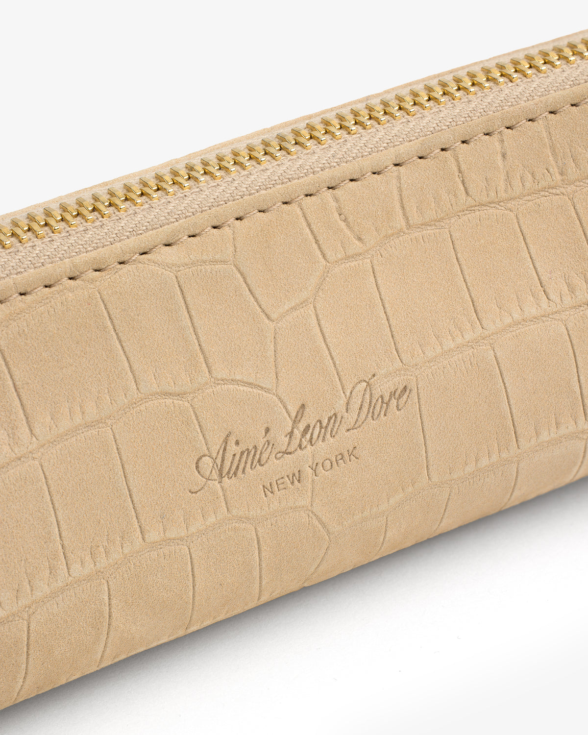 Beige Croc-Embossed Nubuck Pencil Case with gold zipper and “Aimé Leon Dore NEW YORK” logo on the front.