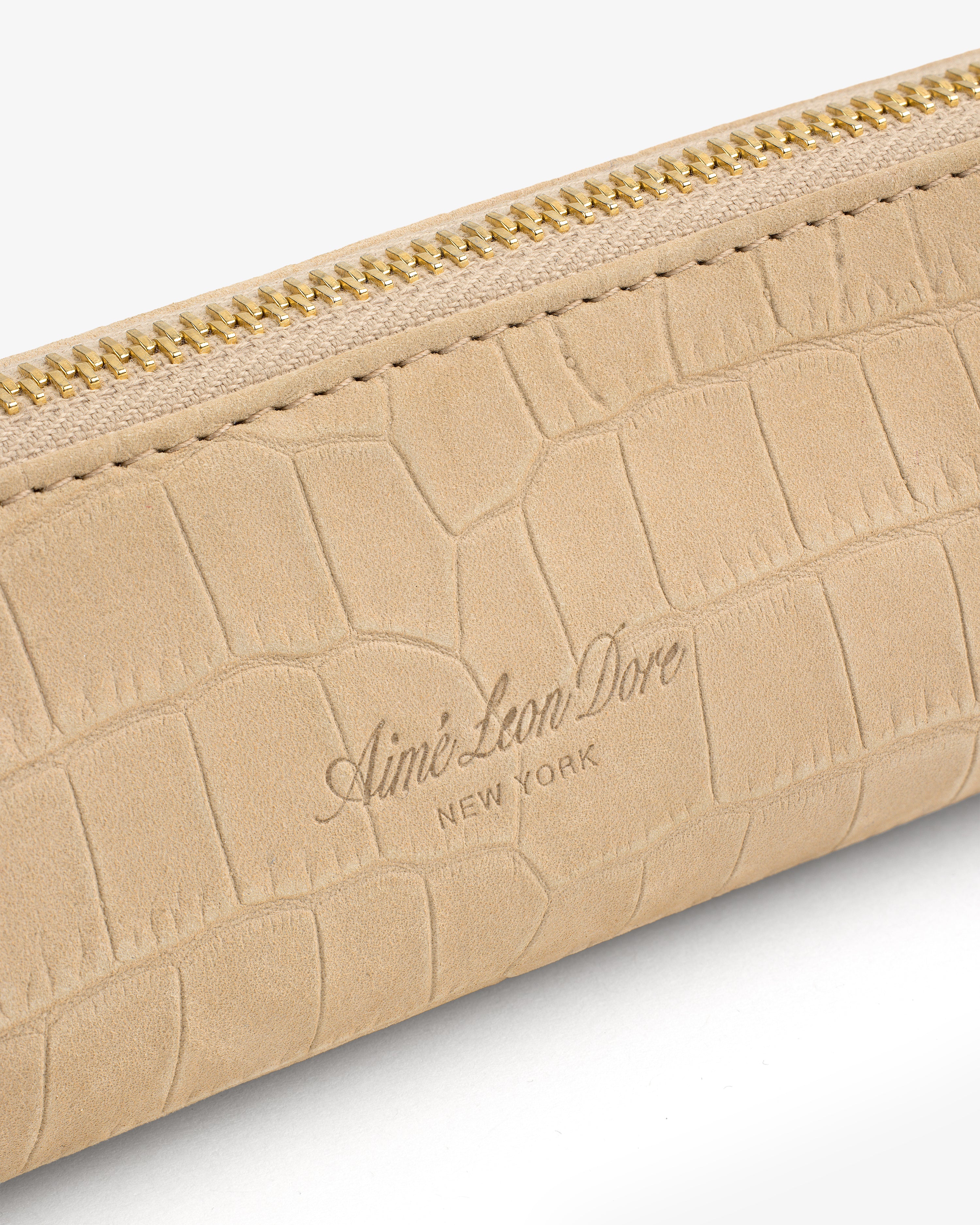 Beige Croc-Embossed Nubuck Pencil Case with gold zipper and “Aimé Leon Dore NEW YORK” logo on the front.