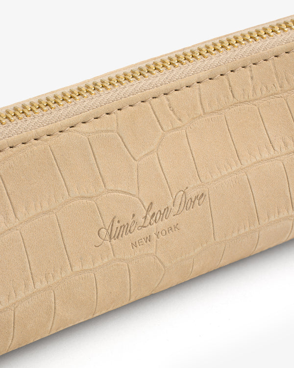 Beige Croc-Embossed Nubuck Pencil Case with gold zipper and “Aimé Leon Dore NEW YORK” logo on the front.
