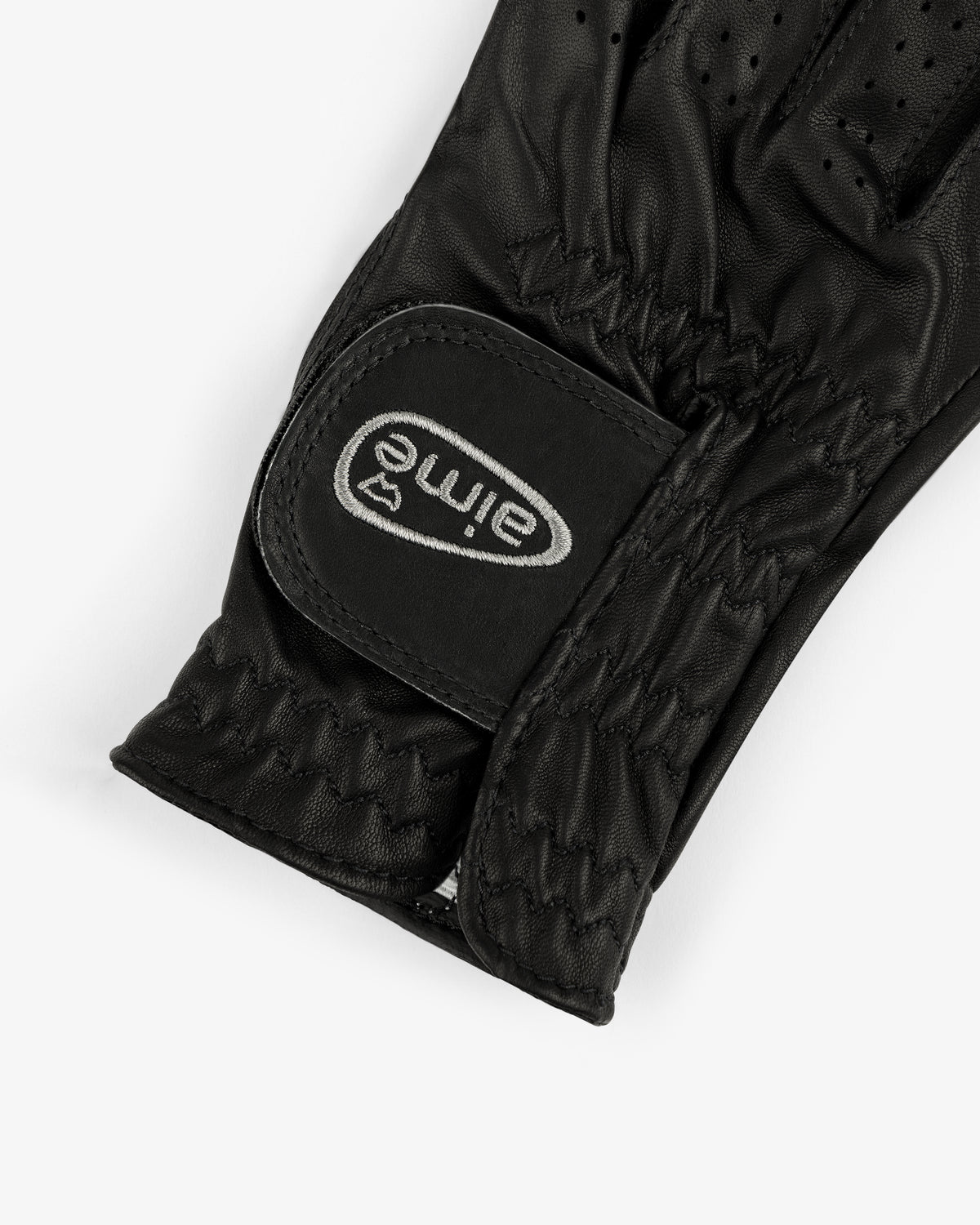 Close-up of an ALD / FootJoy StaSof Heritage Glove (Right) in black leather with stitching and eime Velcro strap.