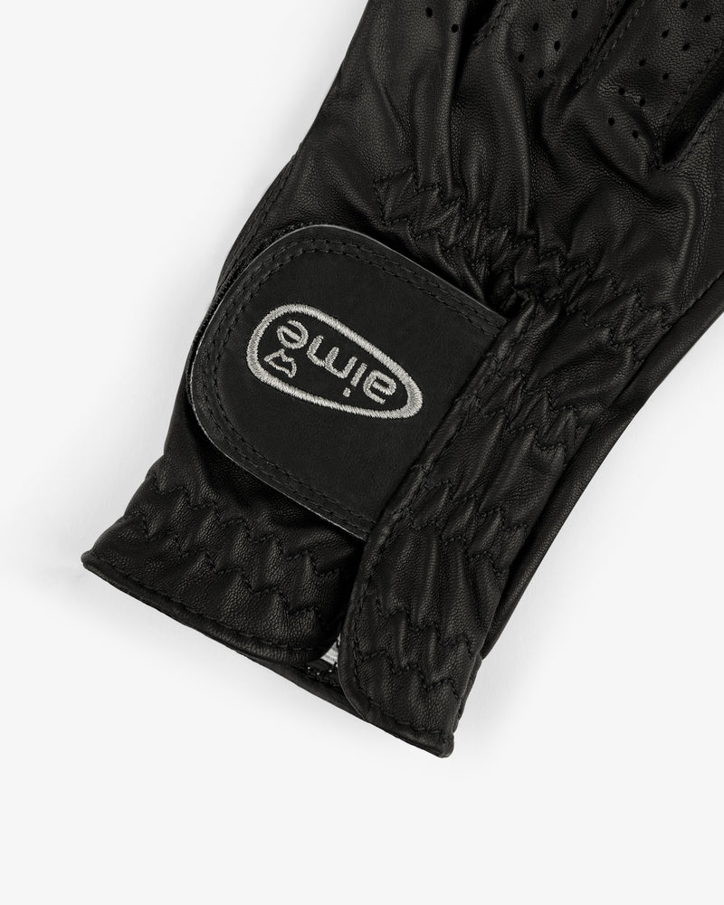 Close-up of an ALD / FootJoy StaSof Heritage Glove (Right) in black leather with stitching and eime Velcro strap.