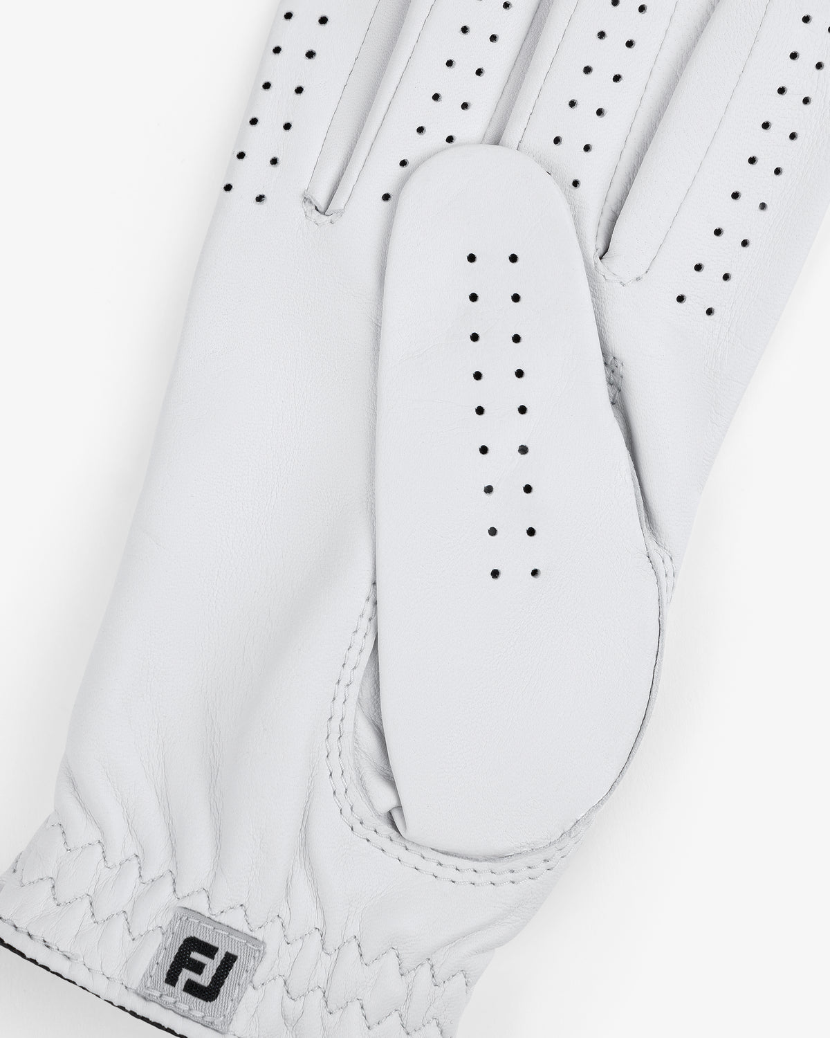 Close-up of the ALD / FootJoy StaSof Heritage Glove (Right) in white leather with perforations and FJ logo by wrist.