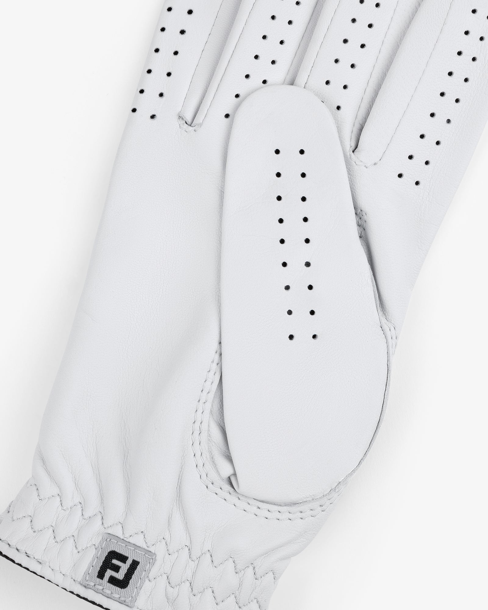 Close-up of the ALD / FootJoy StaSof Heritage Glove (Right) in white leather with perforations and FJ logo by wrist.