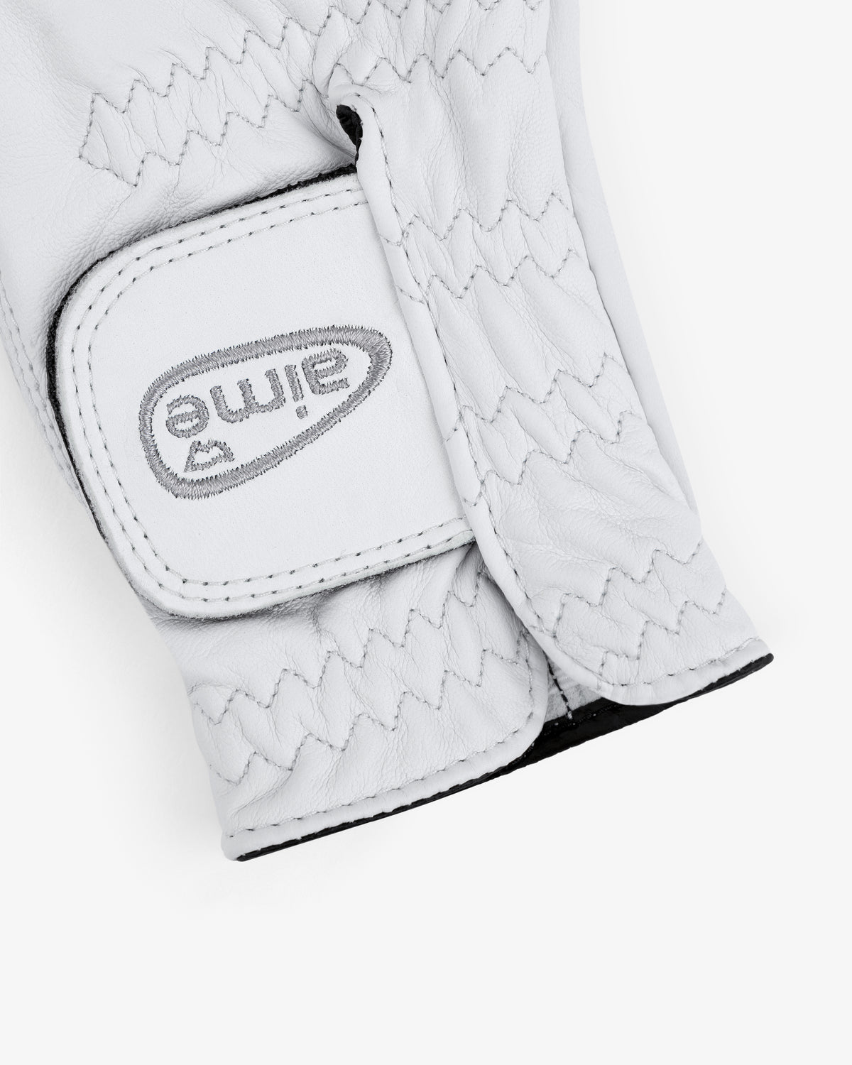 A close-up of the ALD / FootJoy StaSof Heritage Glove (Right) in white leather with visible stitching and a Velcro strap.