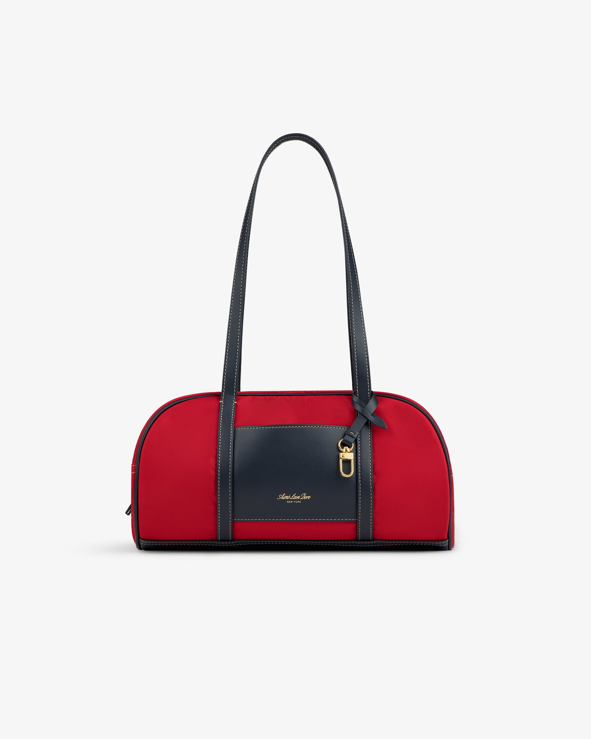 Mini Duffle Shoulder Bag in red with black handles, front pocket, gold buckle, bow detail on white background.