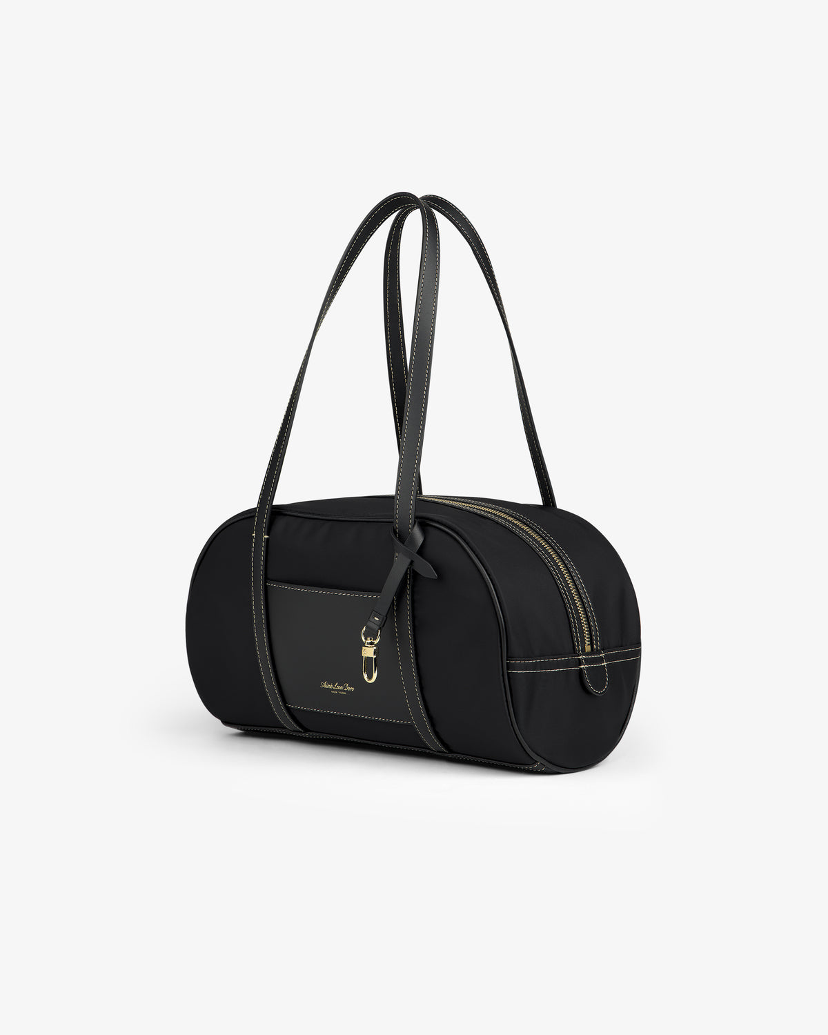 Mini Duffle Shoulder Bag in black, cylindrical shape with double handles, gold zipper, contrast stitching.