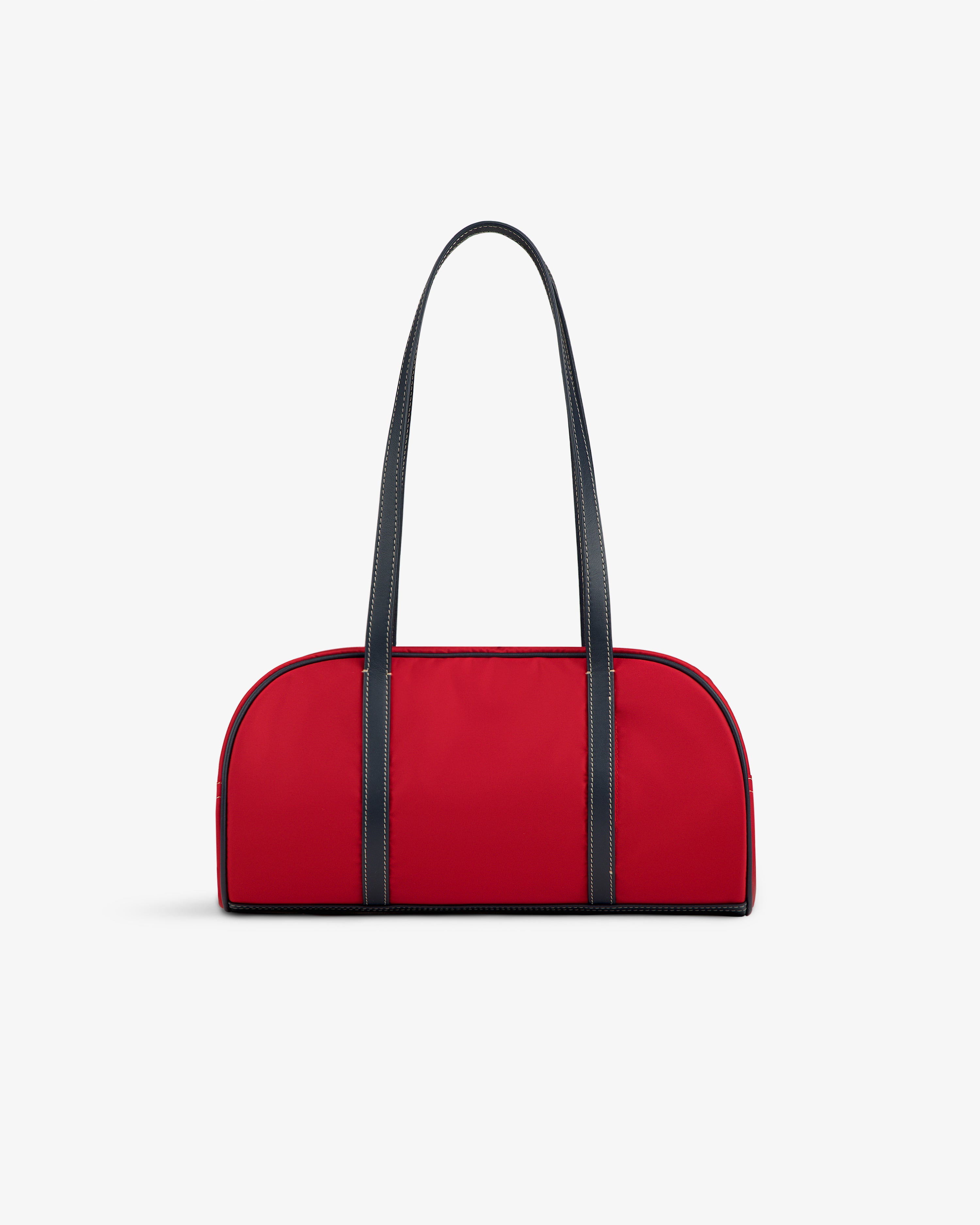 The Mini Duffle Shoulder Bag in red with black handles and trim, shown on a plain white background.