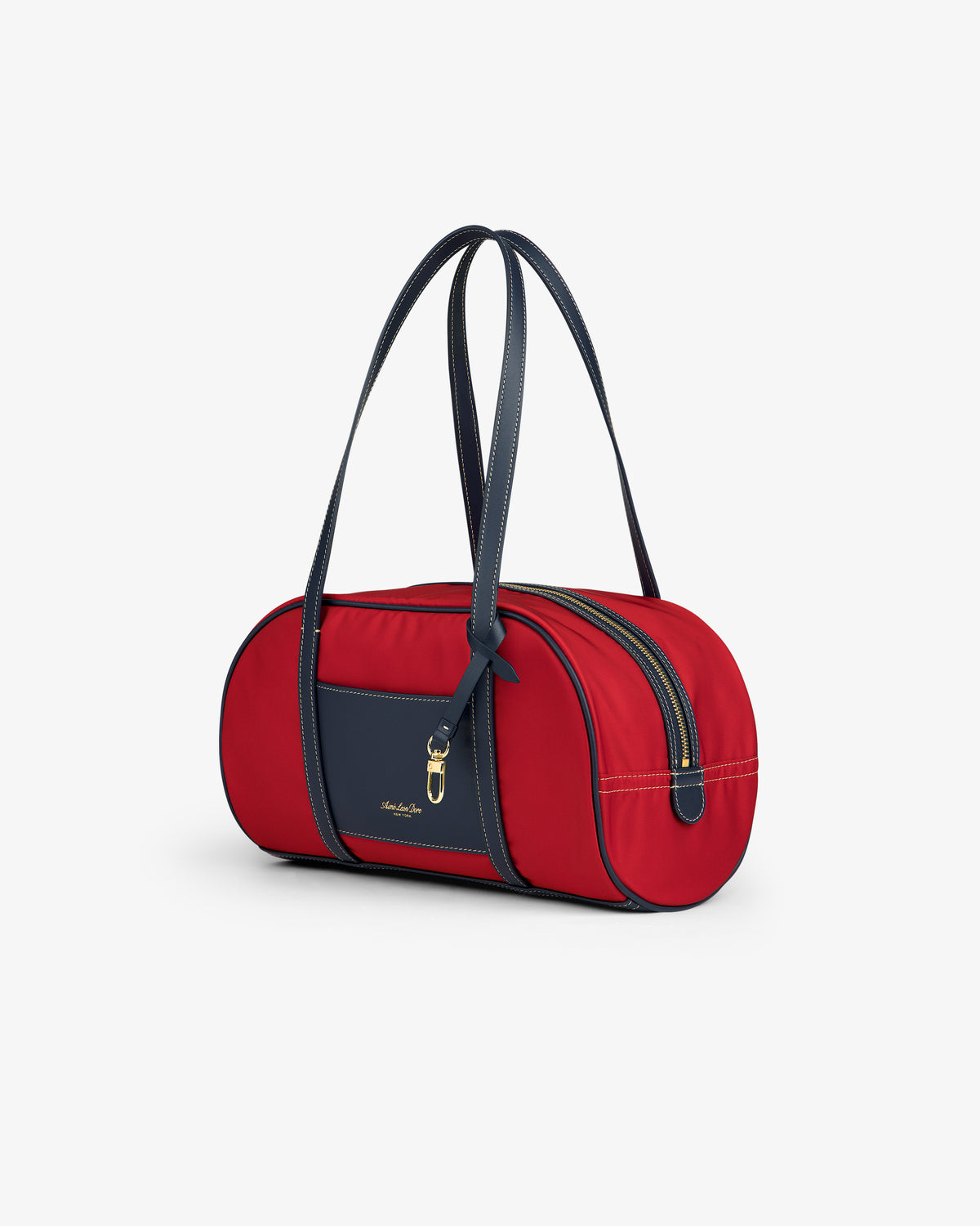 Mini Duffle Shoulder Bag in red, with navy handles, front pocket, and gold zipper, shown on a white background.