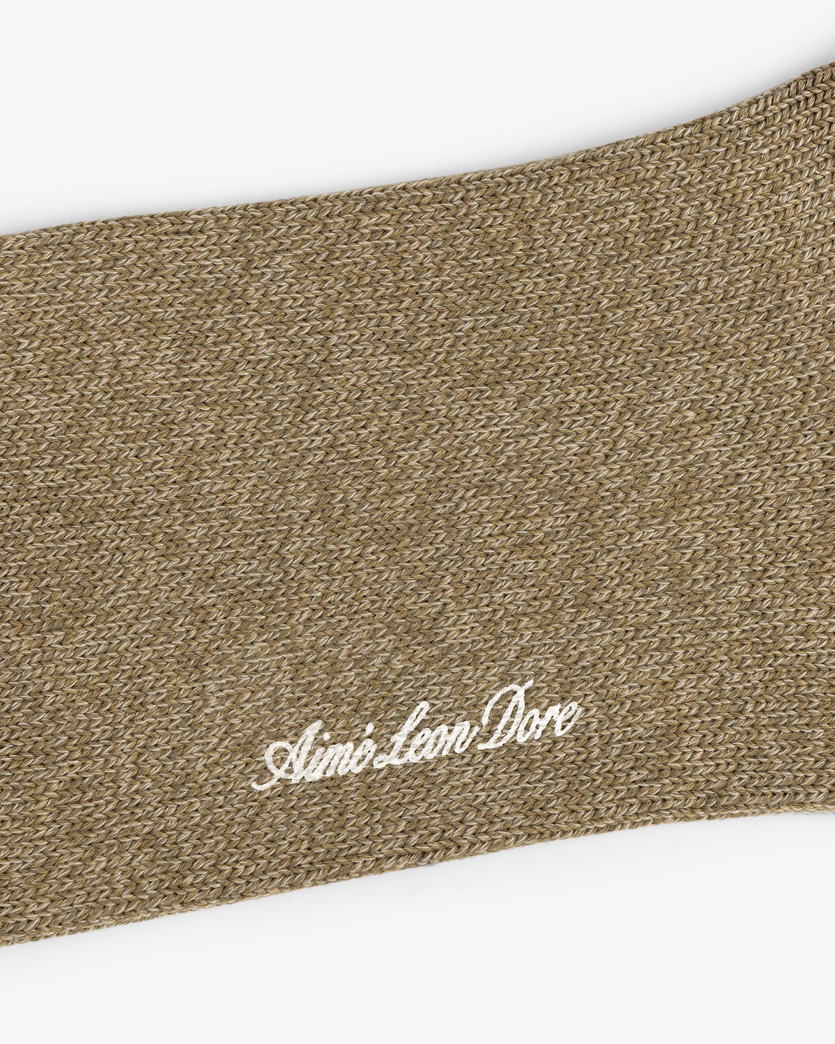 Close-up of a brown knit Marled Quarter Sock with Aimé Leon Dore embroidered in white cursive lettering.