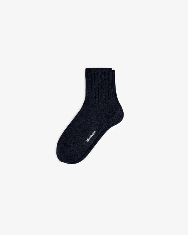 A single Marled Quarter Sock, dark and ribbed with small white text on the sole, shown on a plain white background.
