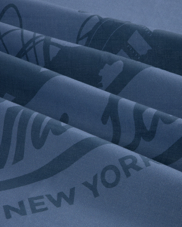 Close-up of blue Sun Faded Unisphere Bandana with partially visible printed text and graphics, including New York.
