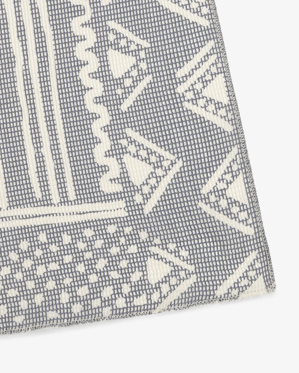Close-up of the Mesh Tapestry Bandana, showing gray and white geometric patterns with triangles and zigzags.