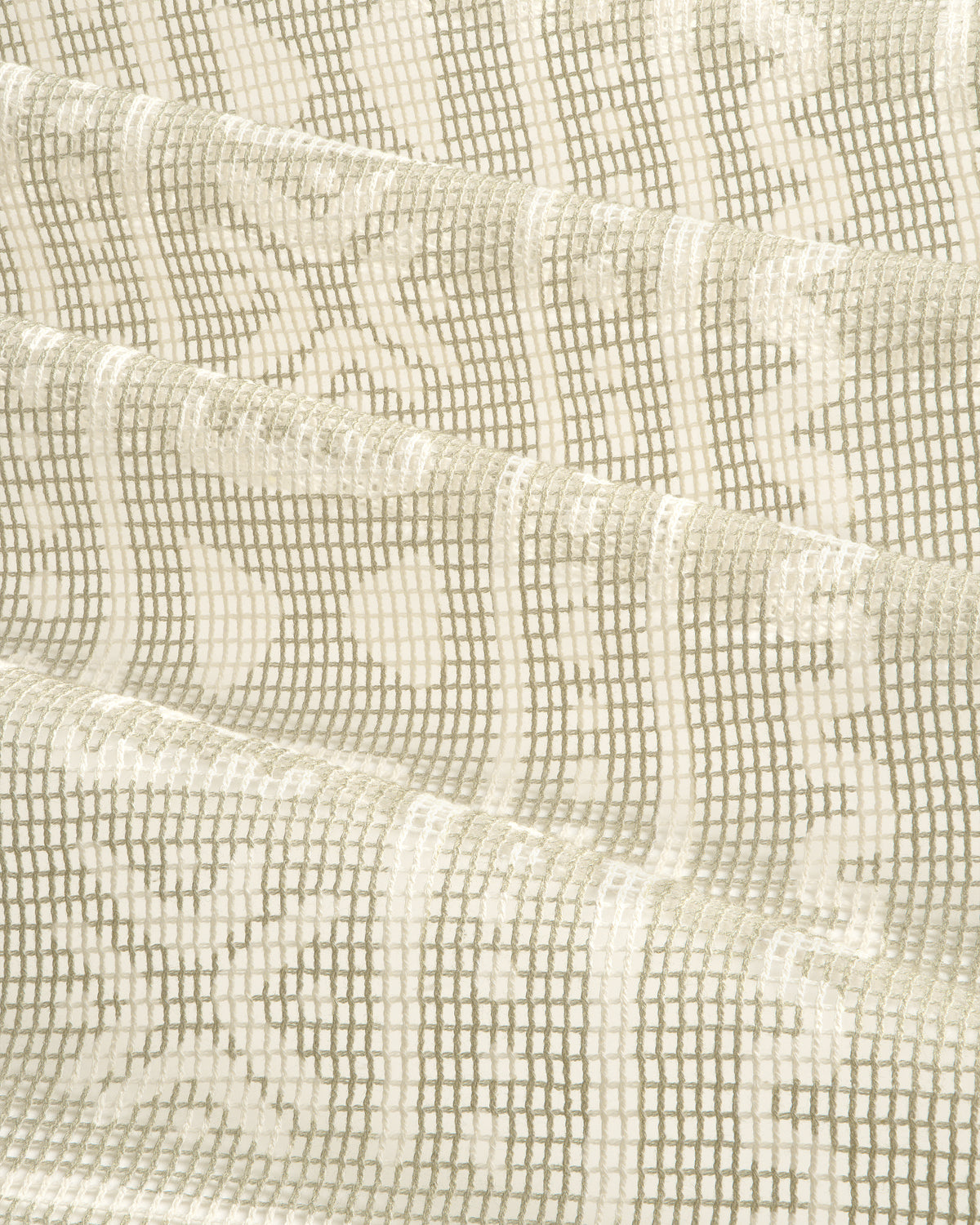 Close-up of the Mesh Tapestry Bandana in cream, featuring a geometric grid and floral pattern, folded in soft waves.