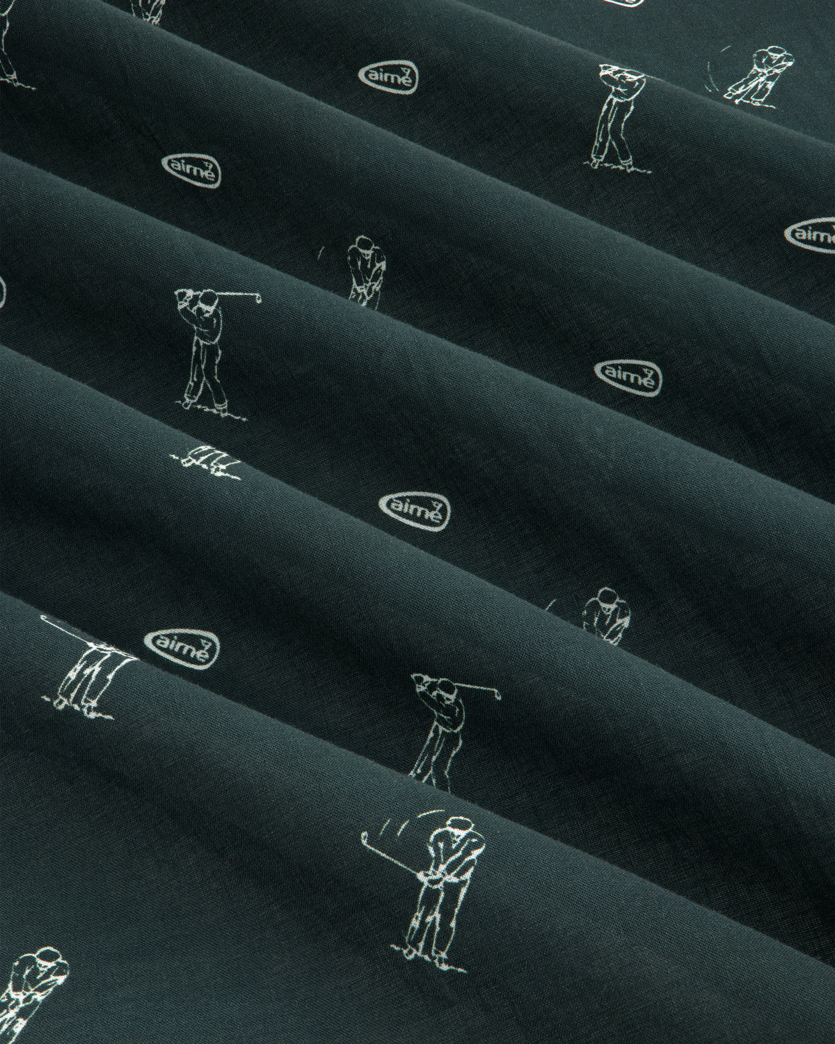 The ALD Golf Swing Bandana features dark fabric with white golfer line art and small airmx logos in diagonal rows.