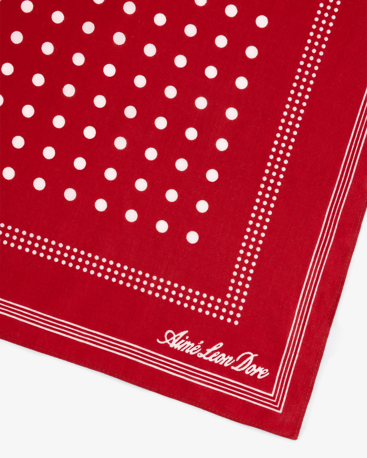 Polka Dot Bandana in red with white dots and Aimé Leon Dore cursive logo on the bottom right corner.