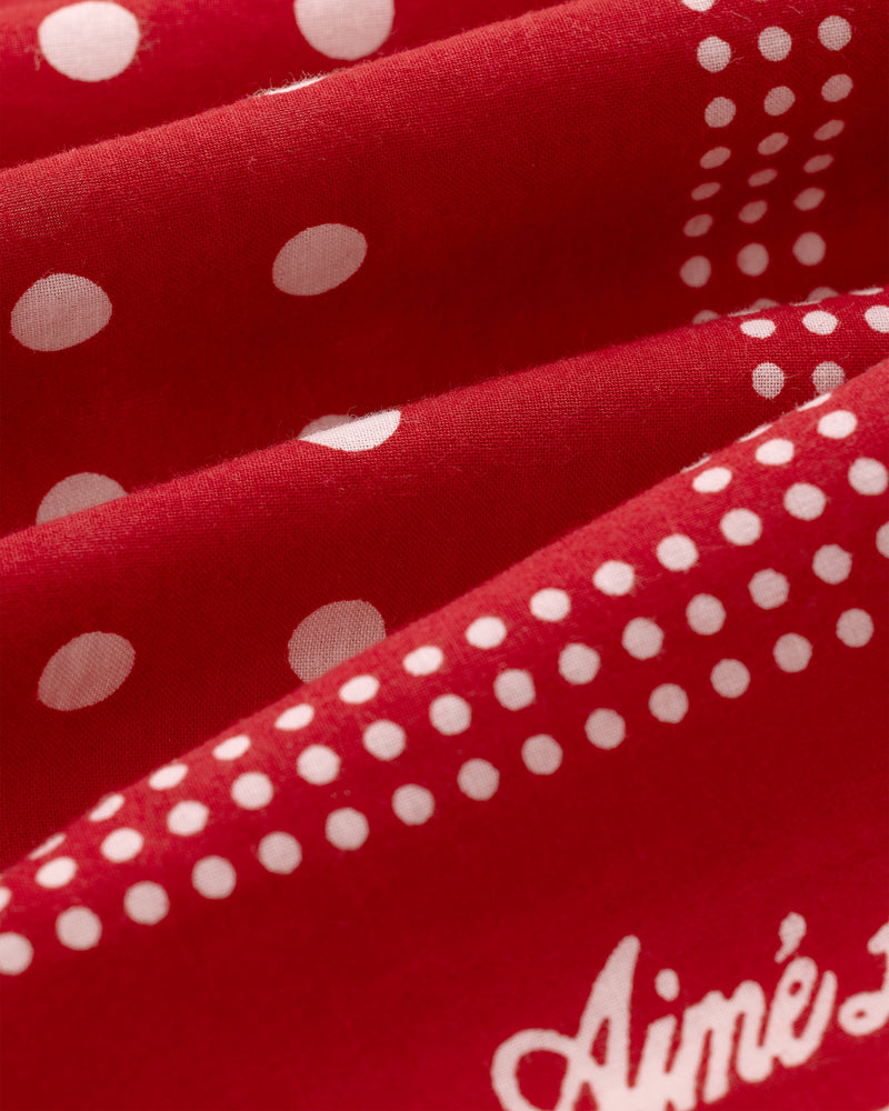 Polka Dot Bandana: Red fabric with white polka dots and "Aimé" partly visible in white script.