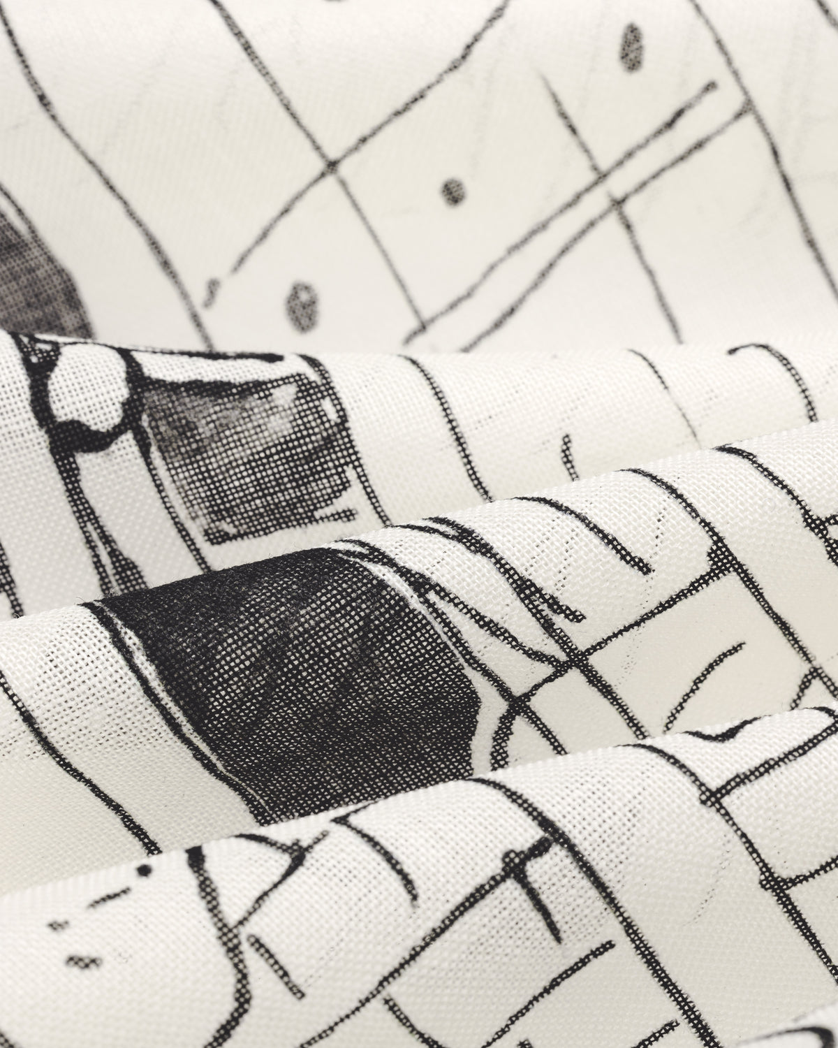 The Fassianos Neighborhood Bandana features white fabric with black abstract, hand-drawn lines and gentle folds.