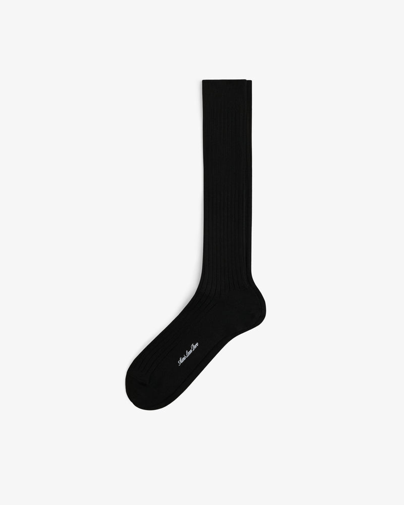 A single black Dress Sock, knee-high and ribbed with white text near the toe, shown on a plain white background.