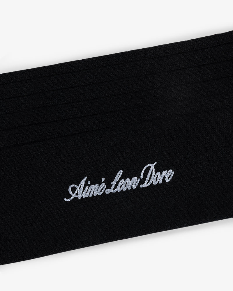 Black Dress Sock with Aimé Leon Dore embroidered in white cursive.
