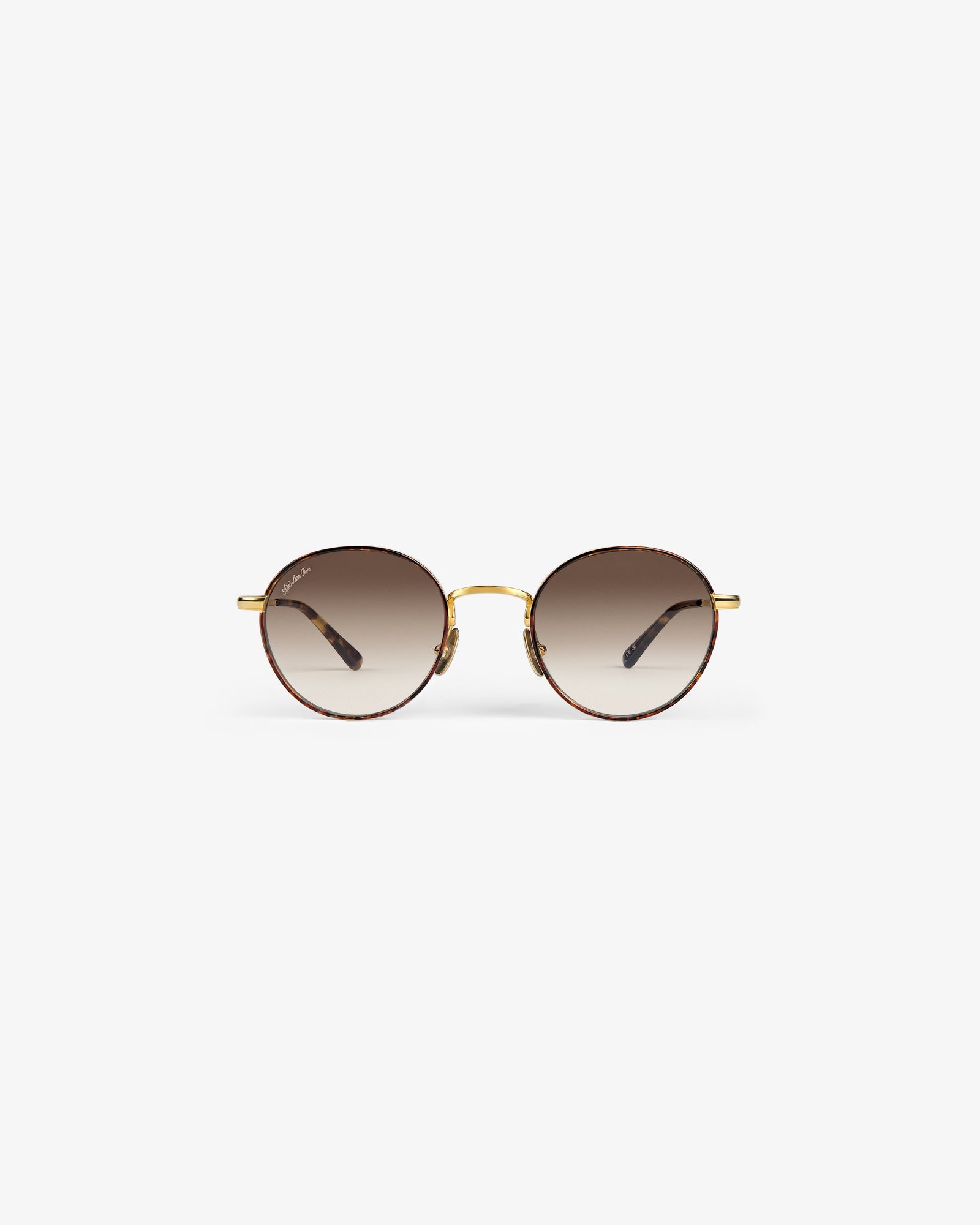 Giórgios Sunglasses: Round frames with brown gradient lenses, gold bridge, and thin gold arms on white background.